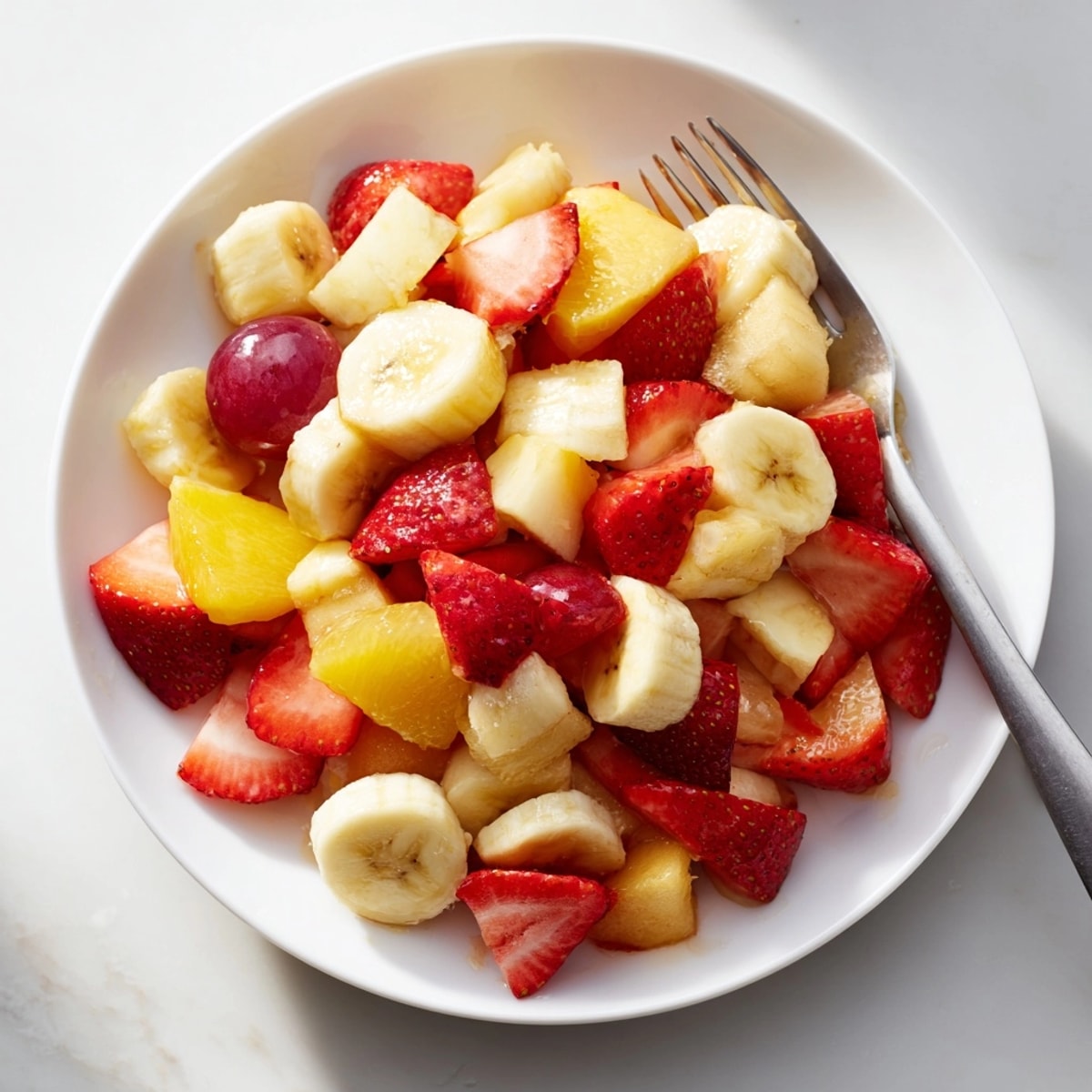 Delicious and refreshing Dole Fruit Salad with strawberries and grapes ready to serve.