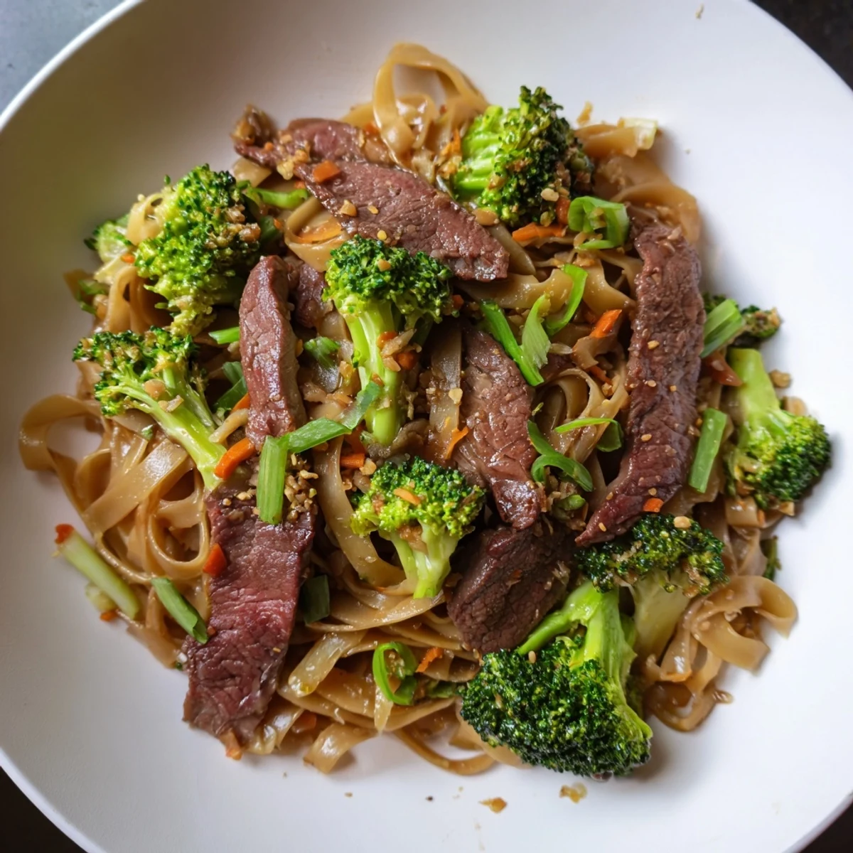 Enjoy a close-up of Beef and Broccoli Noodles—savory noodles, beef strips, and crisp broccoli florets tossed in sauce.