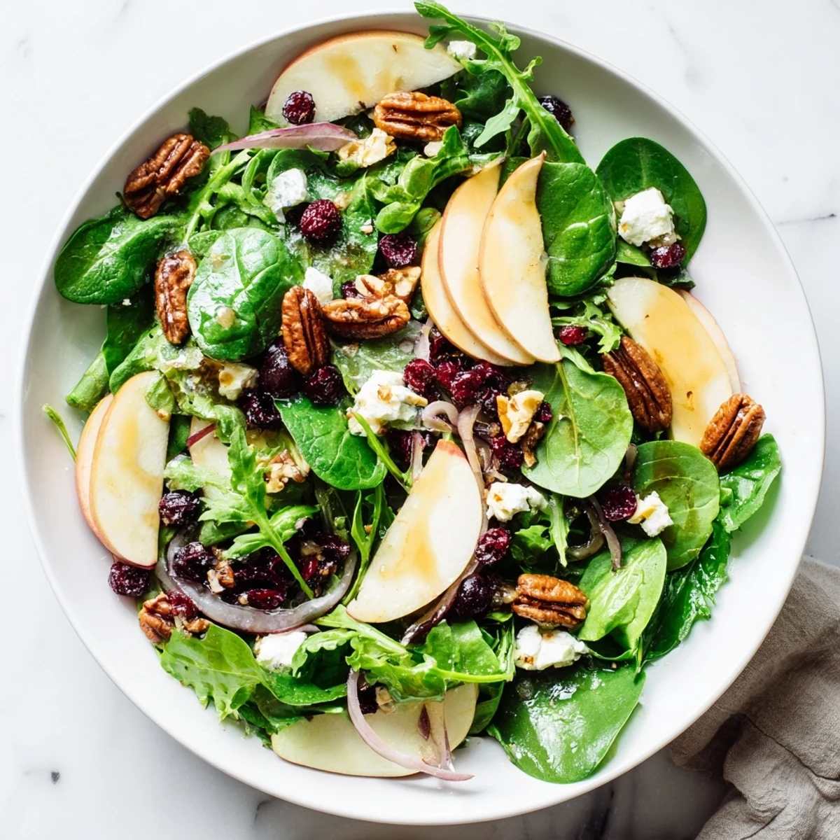 Enjoy a refreshing Cranberry Pecan Salad with sweet-tart cranberries and a tangy vinaigrette dressing.