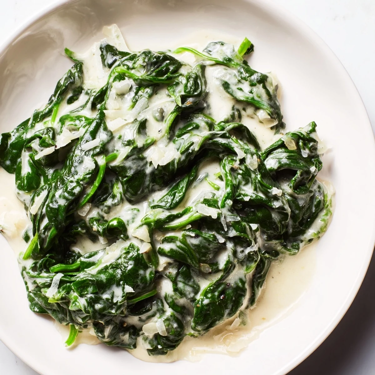 Savory creamy spinach side dish, ready to serve, perfect next to grilled salmon and other entrees.