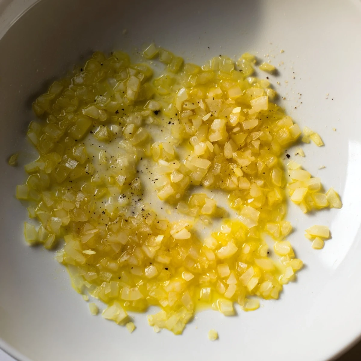 Golden, caramelized Garlic Onion Sauté sizzling in a skillet, creating a delicious, flavorful base.