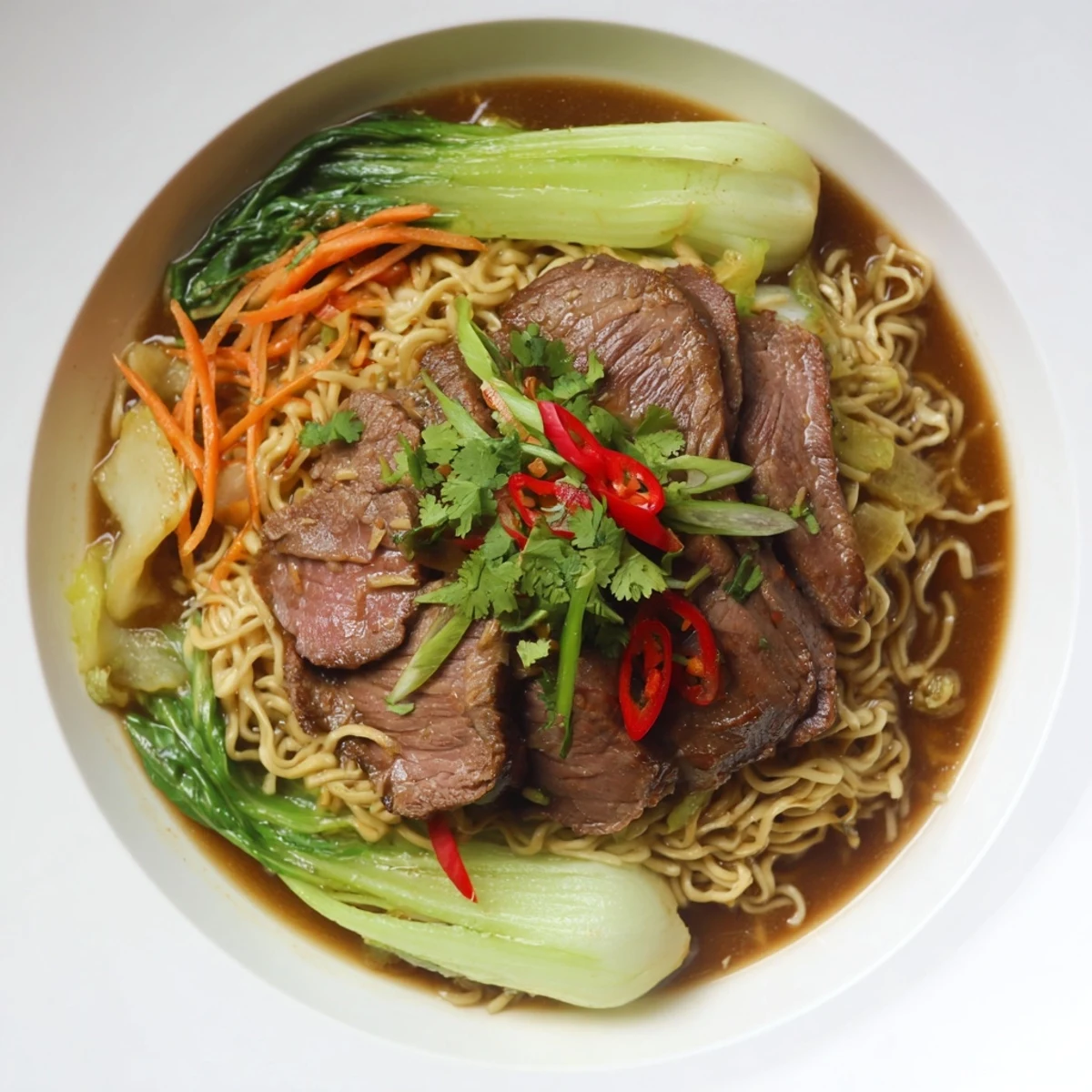 Steaming bowl of Beef Noodles with tender beef, noodles, and fresh, colorful garnishes.