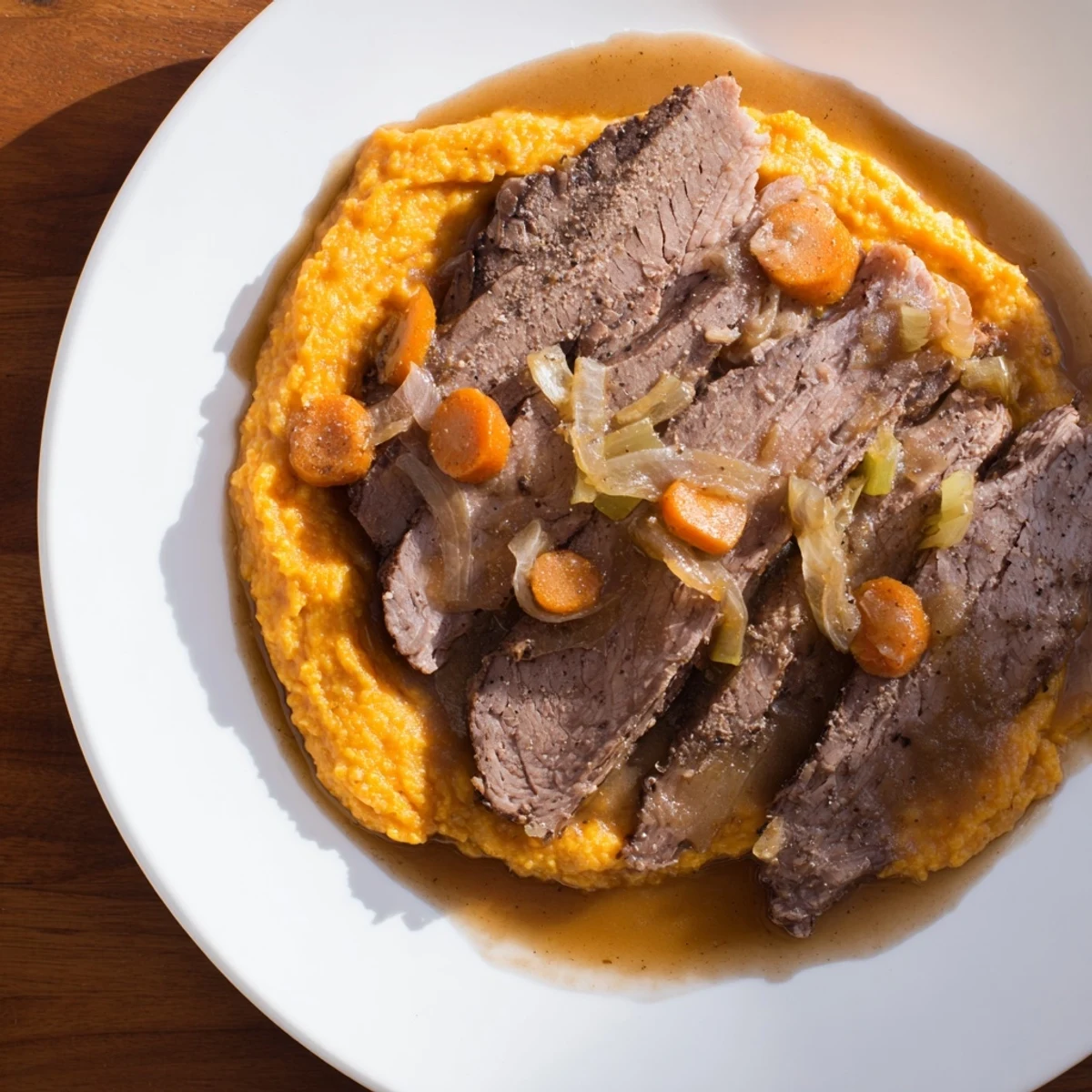 Slow-cooked, fall-apart beef brisket on creamy sweet potato mash, enriched by a rich braising sauce.