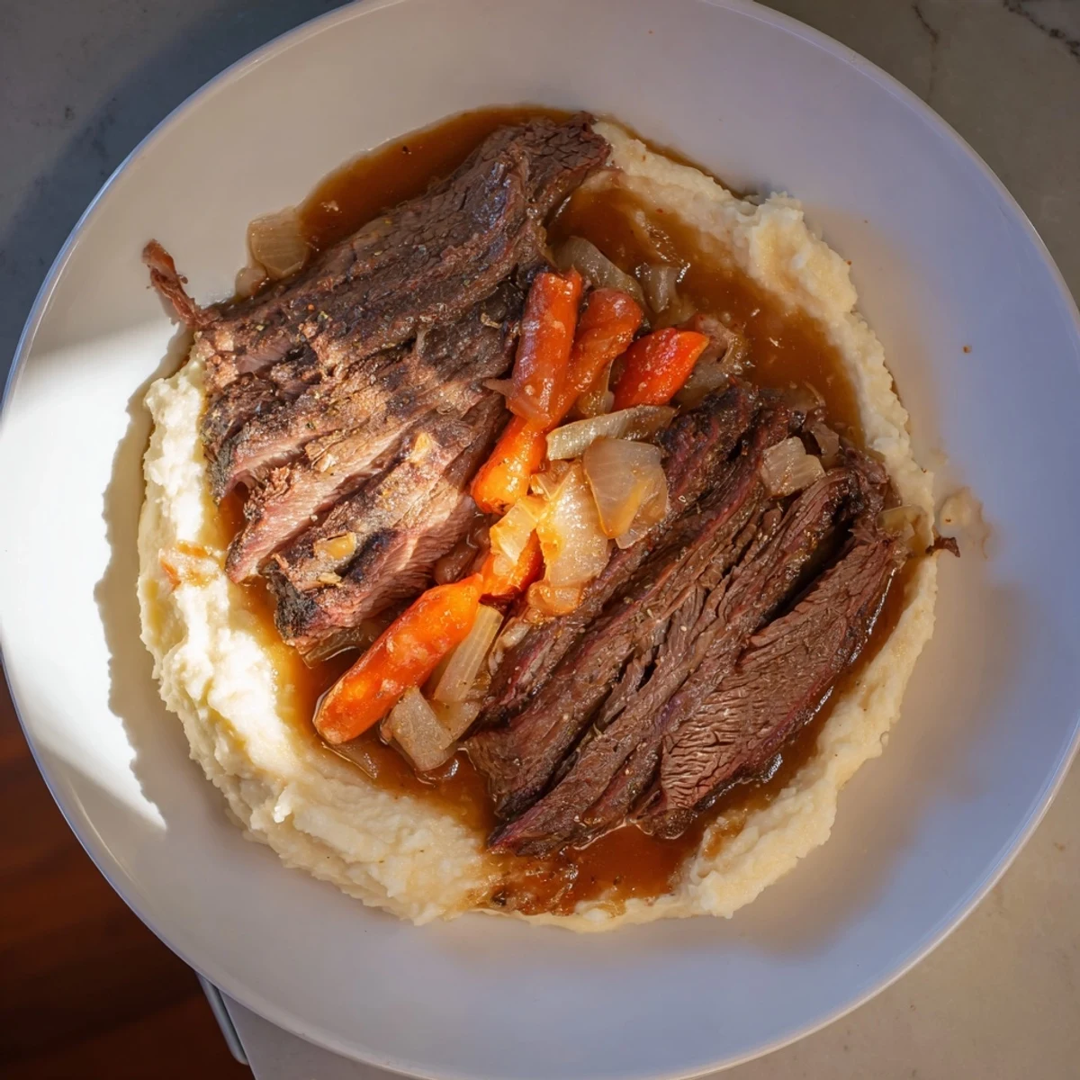 Picture perfect: Sliced beef brisket served with fluffy sweet potato mash and a hearty gravy, American style.