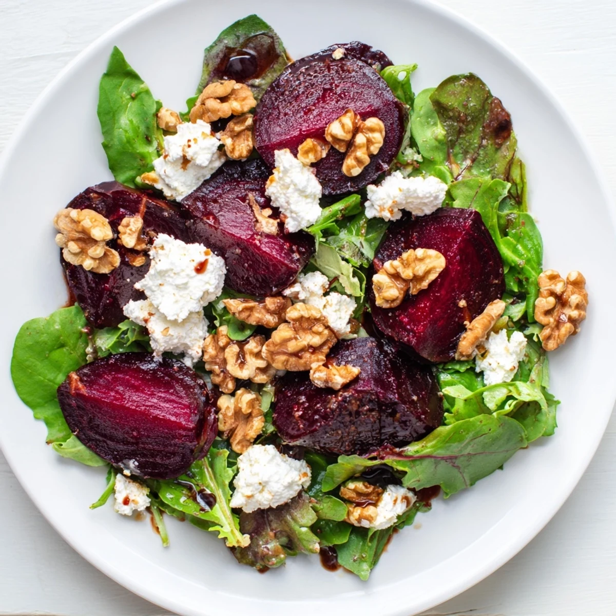 Sweet roasted beetroot wedges in a rich Roasted Beetroot and Walnut Salad, drizzled with vinaigrette.