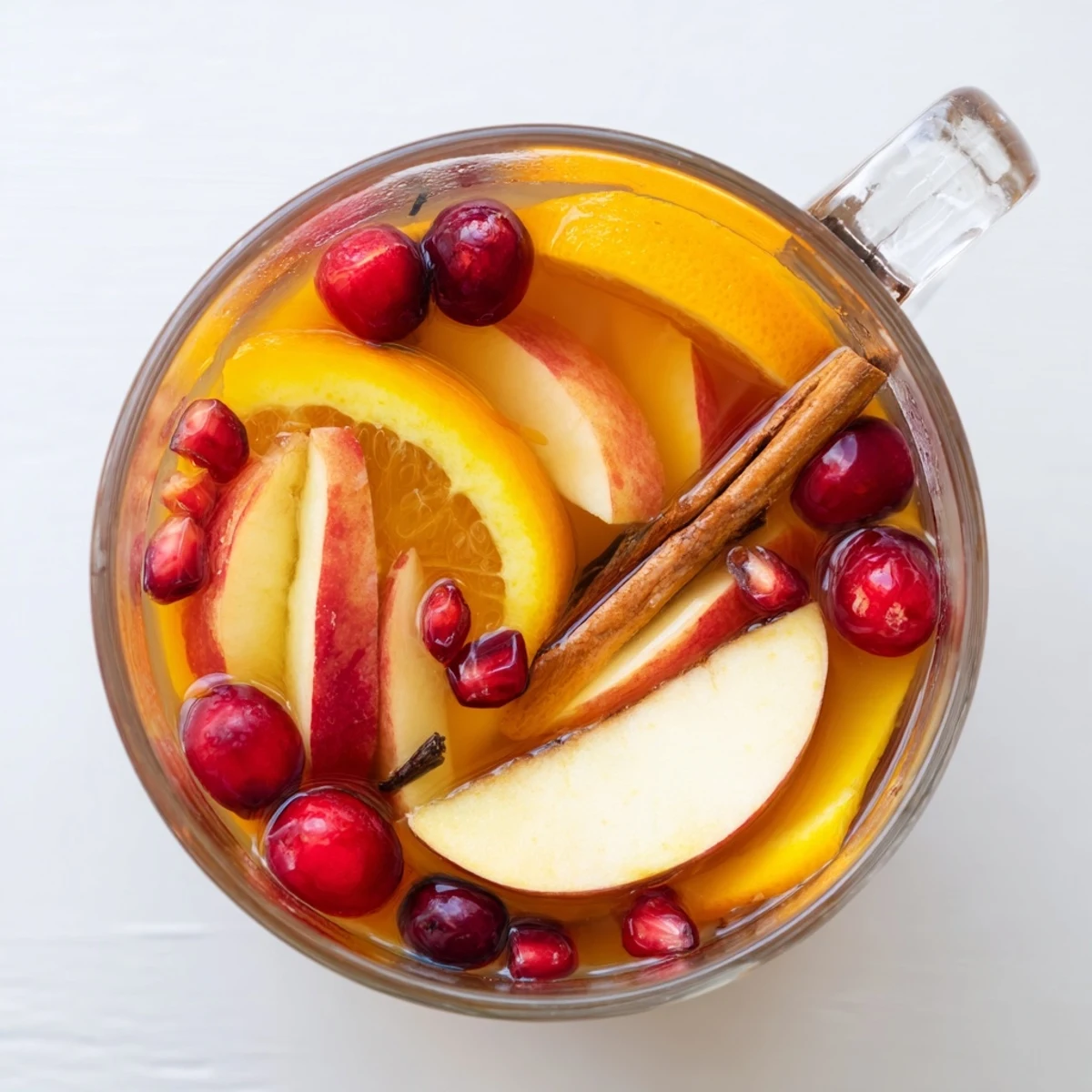 Bright red and orange winter fruit punch, simmering gently with cinnamon and cloves for maximum flavor.