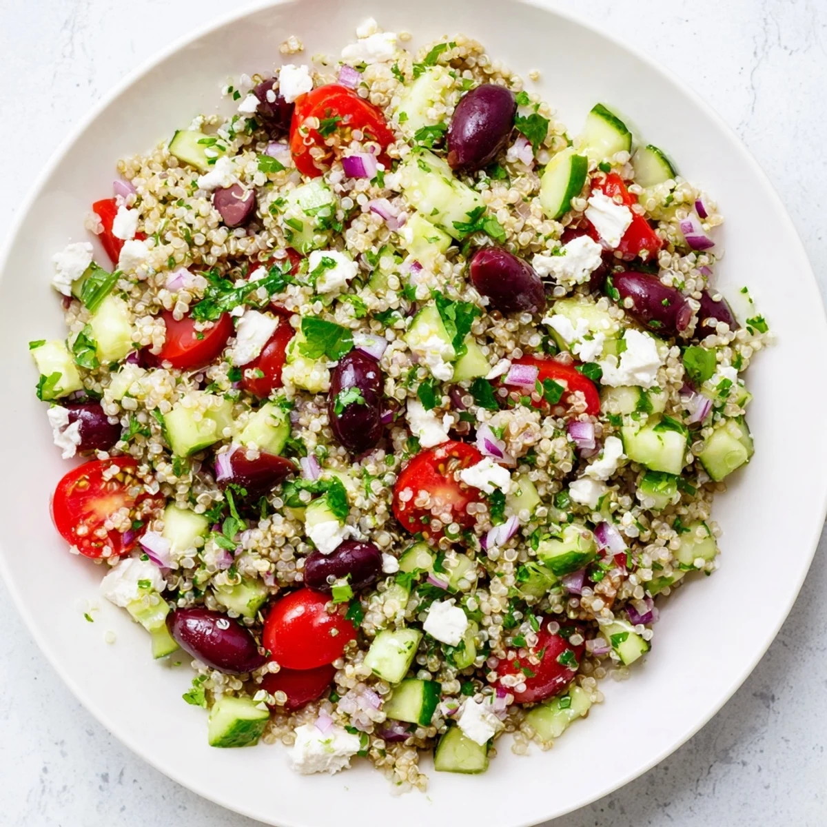 This beautiful bowl of Mediterranean Quinoa Salad features fluffy quinoa, herbs, and a lemon dressing.