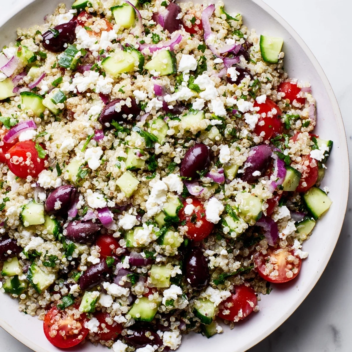 A bright, colorful Mediterranean Quinoa Salad with fresh vegetables and creamy feta cheese.