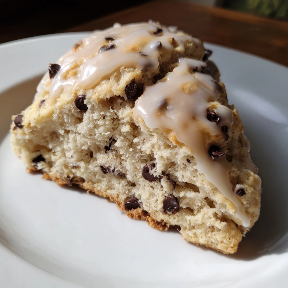 Golden-brown chocolate chip scones, featuring a sweet glaze and visible chocolate in every bite.