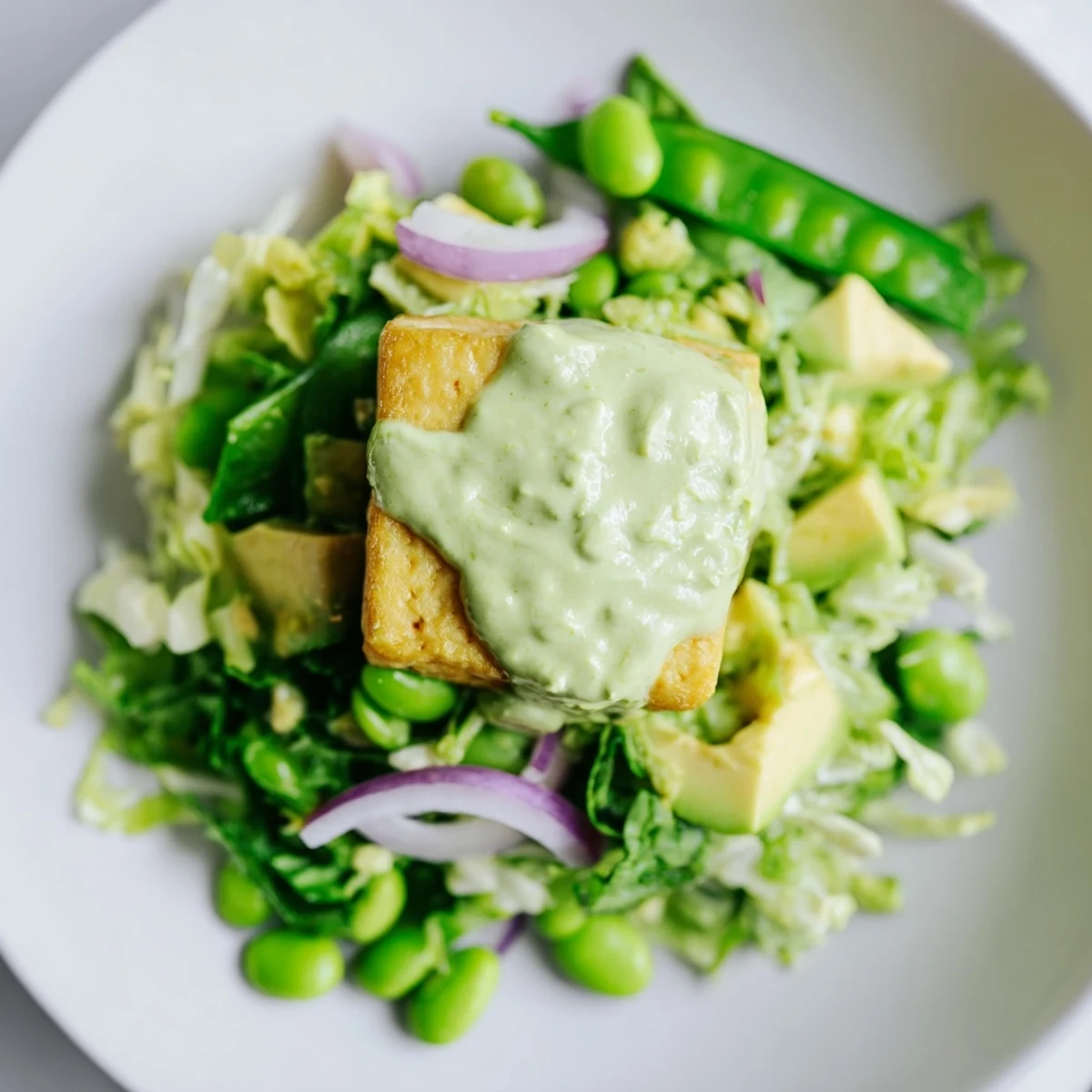 A vibrant serving of Green Goddess Salad with Baked Tofu, topped with golden baked tofu cubes and fresh herbs, ready to be enjoyed for lunch or dinner.