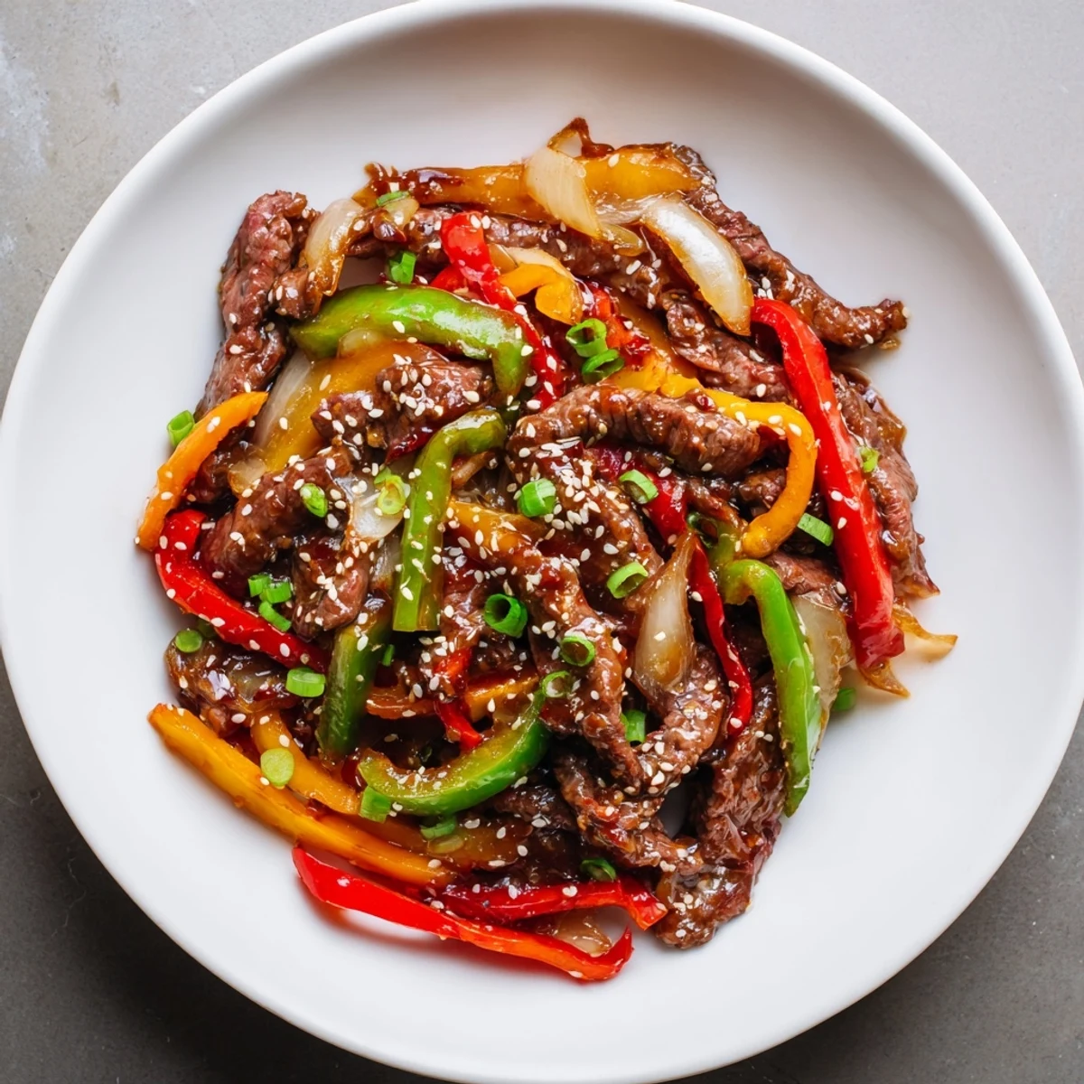 Tender strips of beef and colorful bell peppers in a sizzling Spicy Beef and Pepper Stir Fry.