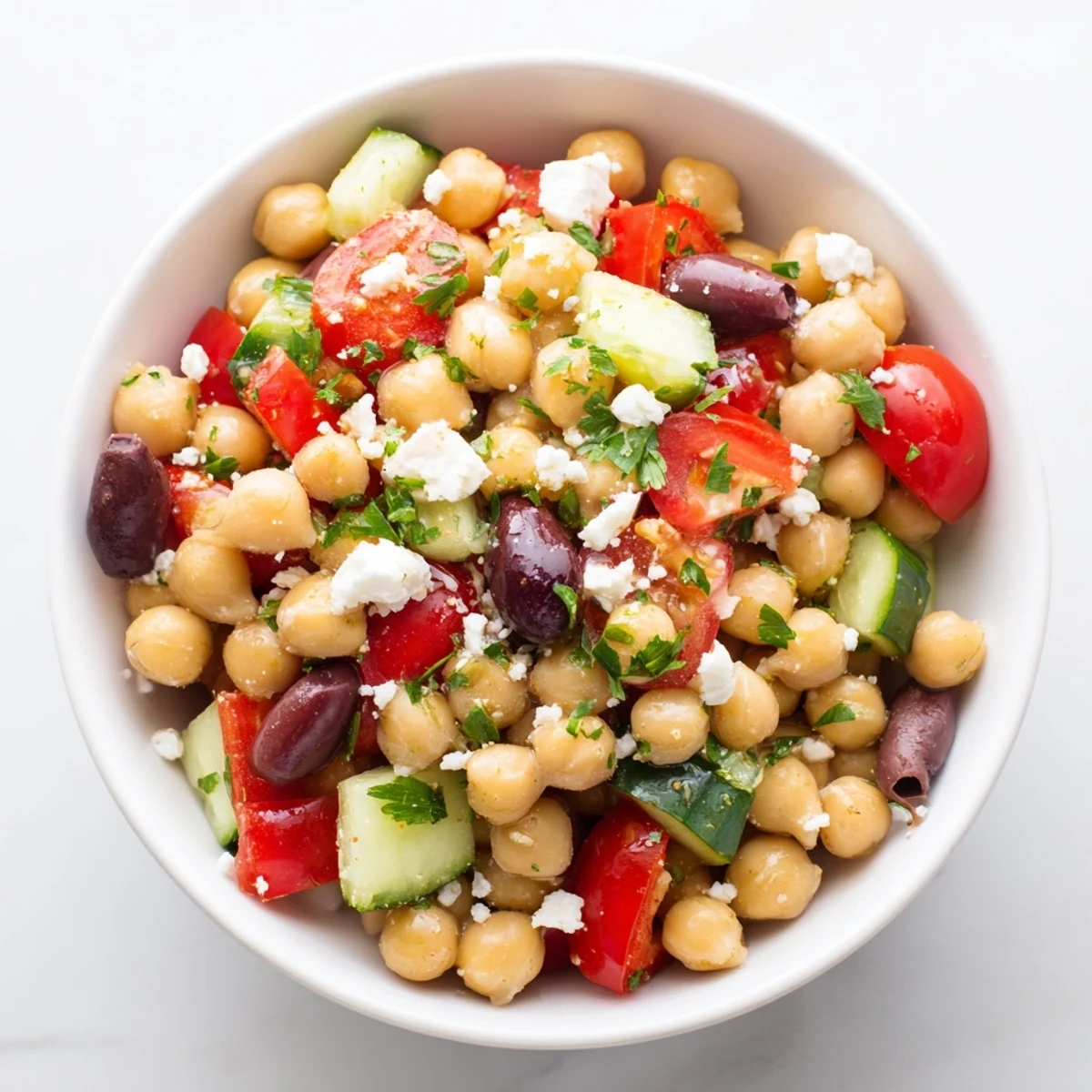Bright and colorful Mediterranean Chickpea Salad with cherry tomatoes, cucumber, and Kalamata olives, tossed in a zesty lemon vinaigrette.