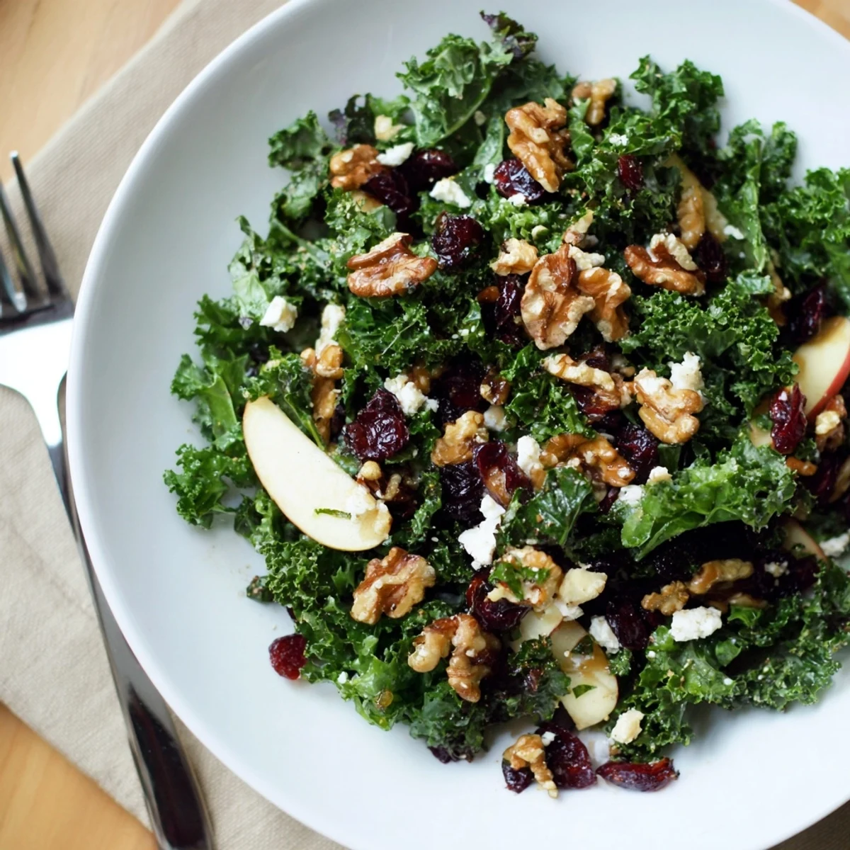 Massaged kale salad with cranberries, apples, and toasted pecans tossed in a zesty maple-Dijon vinaigrette.