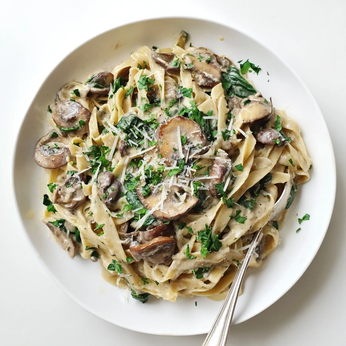 Golden sautéed mushrooms and fresh spinach in creamy pasta, served hot with a garnish of grated Parmesan cheese.  