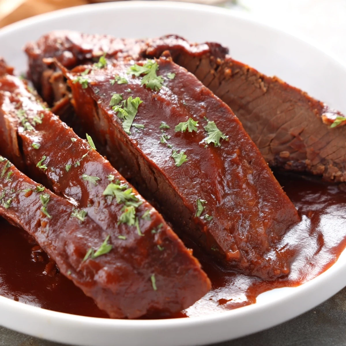 Shredded Slow Cooker Beef Brisket with BBQ Sauce piled high in a slow cooker, bubbling with rich, homemade barbecue sauce.