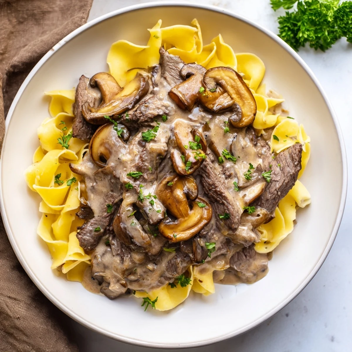 Tender beef strips in creamy mushroom sauce over buttery egg noodles, a classic Beef Stroganoff with Egg Noodles.