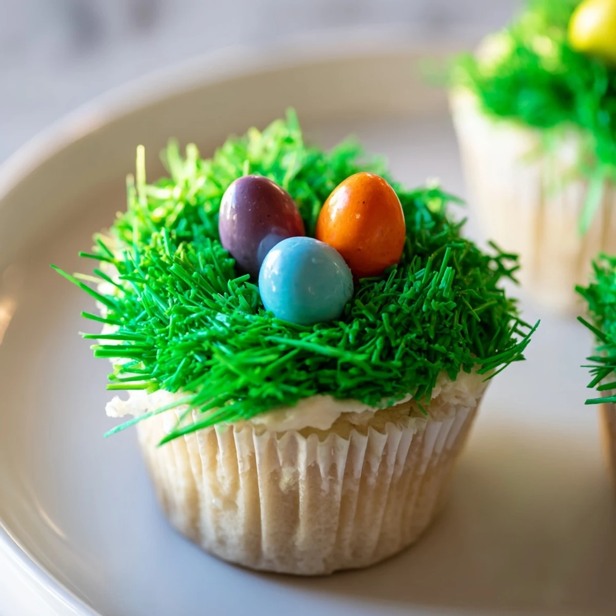 Frosted Easter Basket Cupcakes display licorice handles and candy eggs on a spring pastel backdrop.