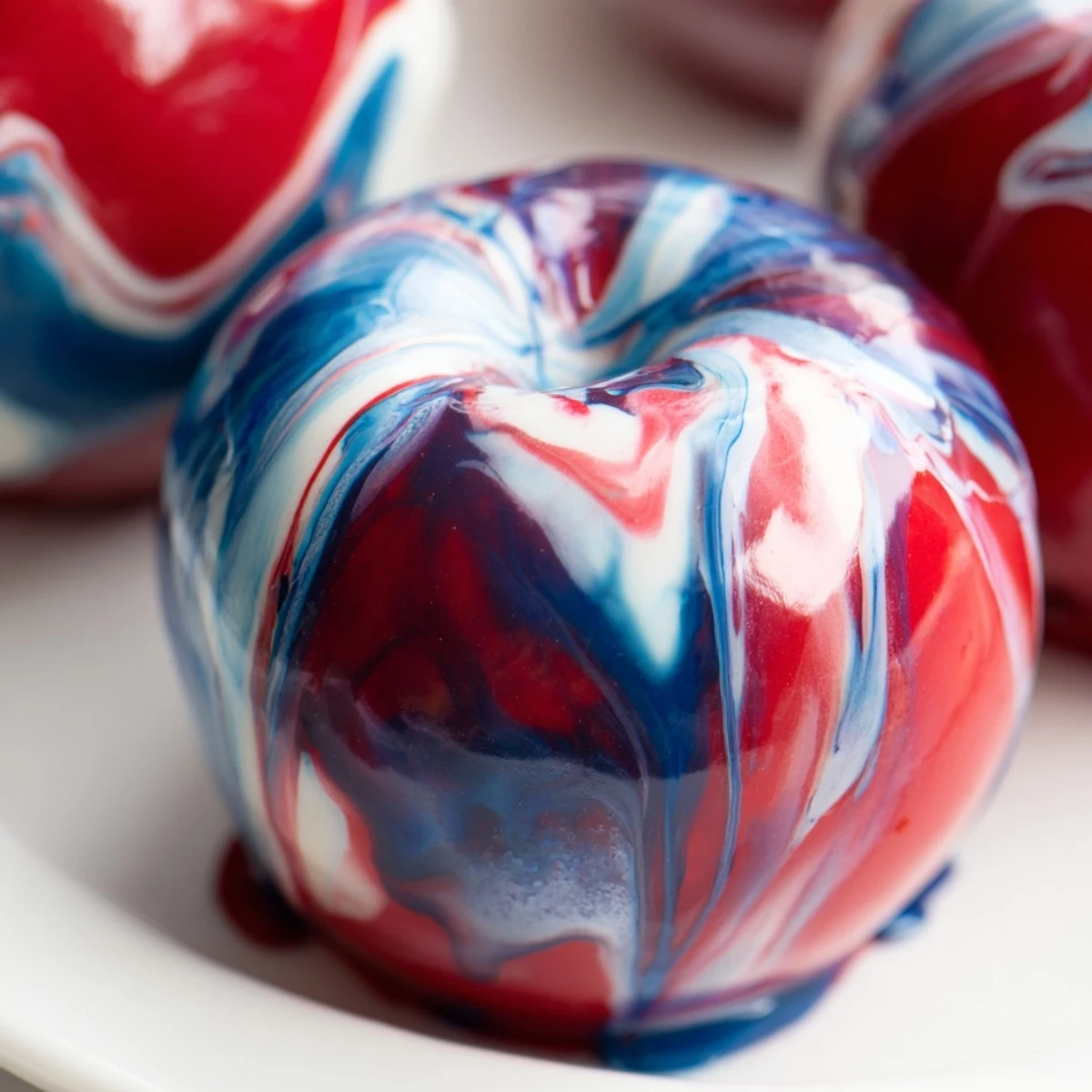Bright marbled effect candy apples with crunchy sticks are ready to serve at a cheerful autumn party or event.