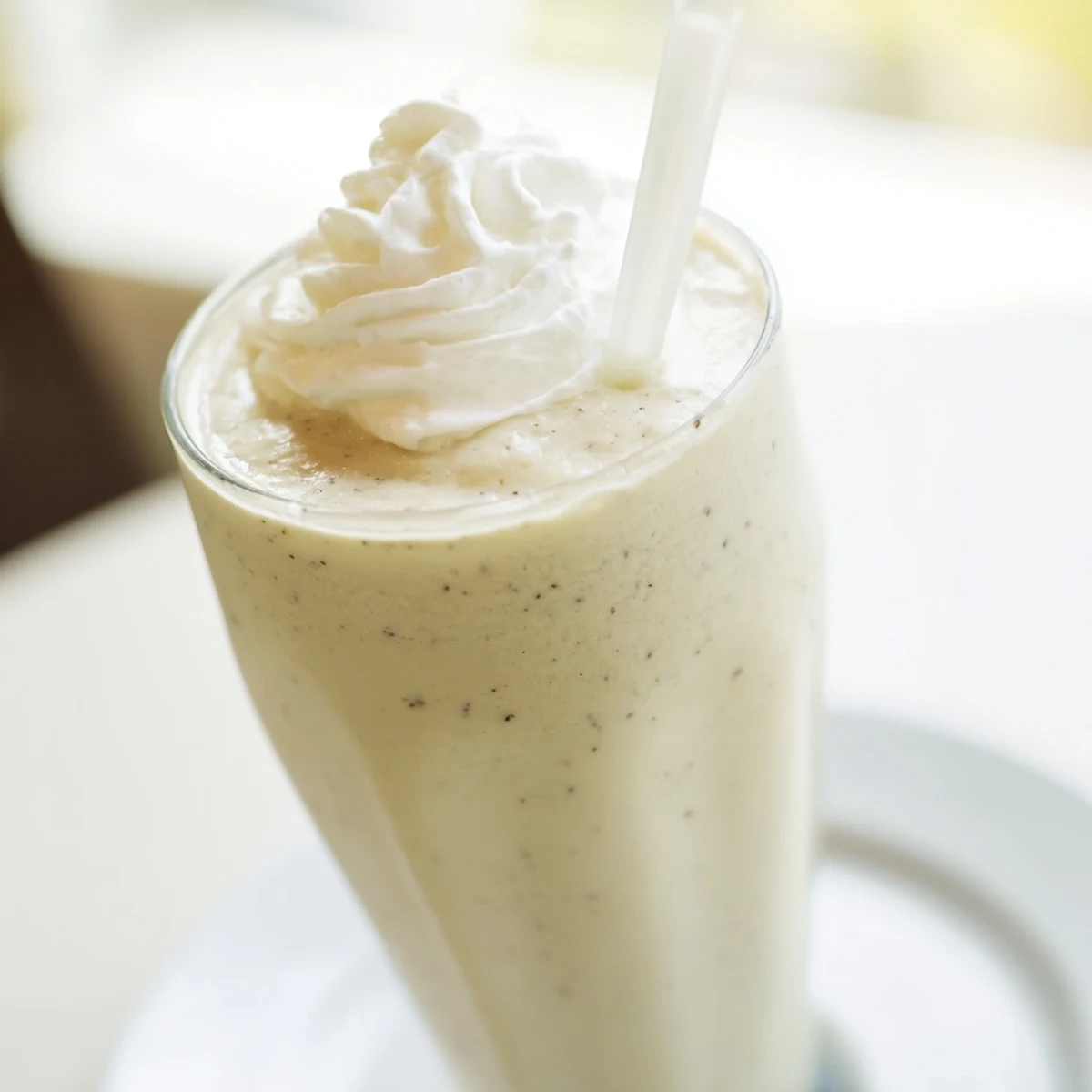 This creamy Starbucks Vanilla Bean Frappuccino features visible ice crystals and a drizzle of vanilla syrup for a refreshing look.