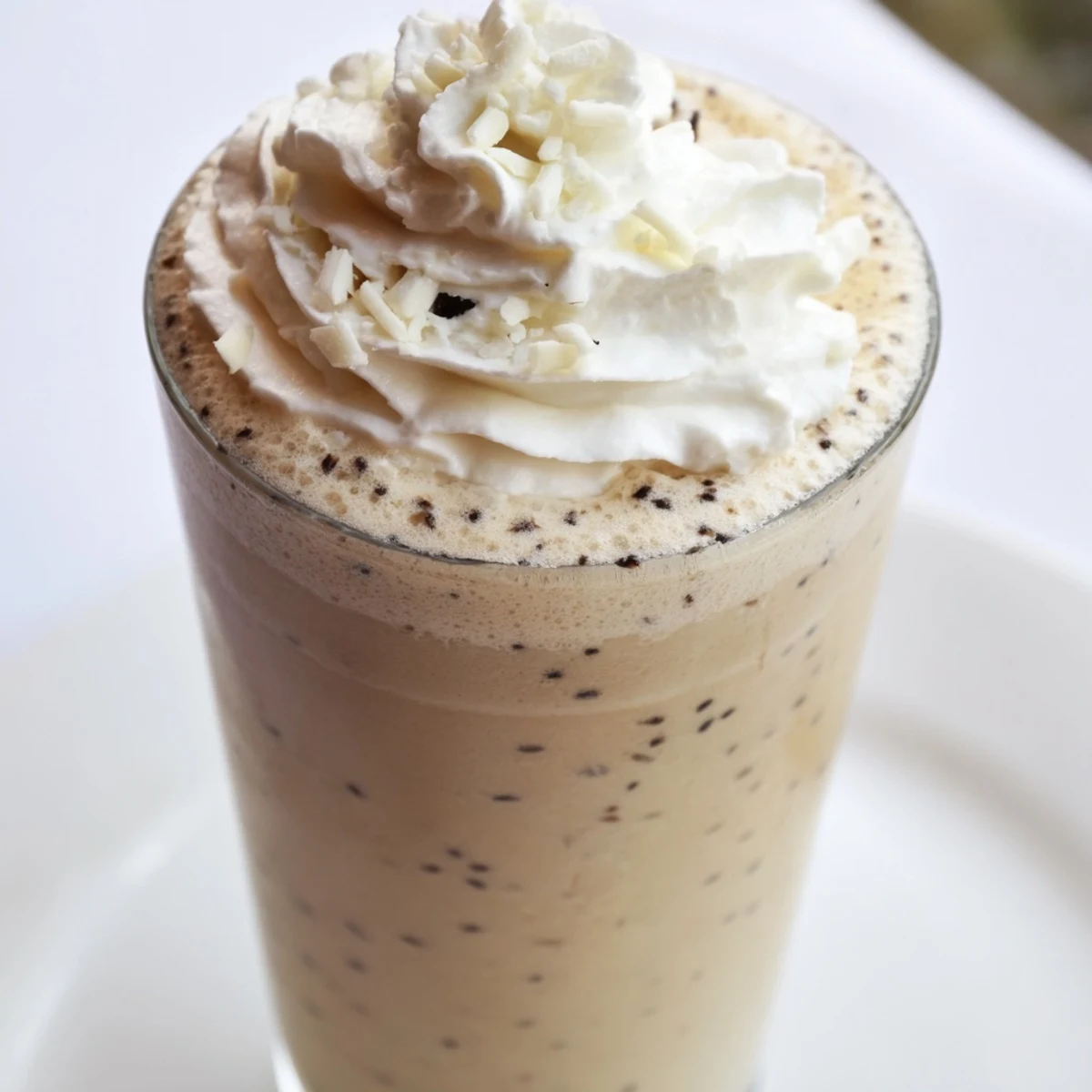 Two glasses of Vanilla Bean Frappuccino with a rich, frosty texture and visible vanilla specks.
