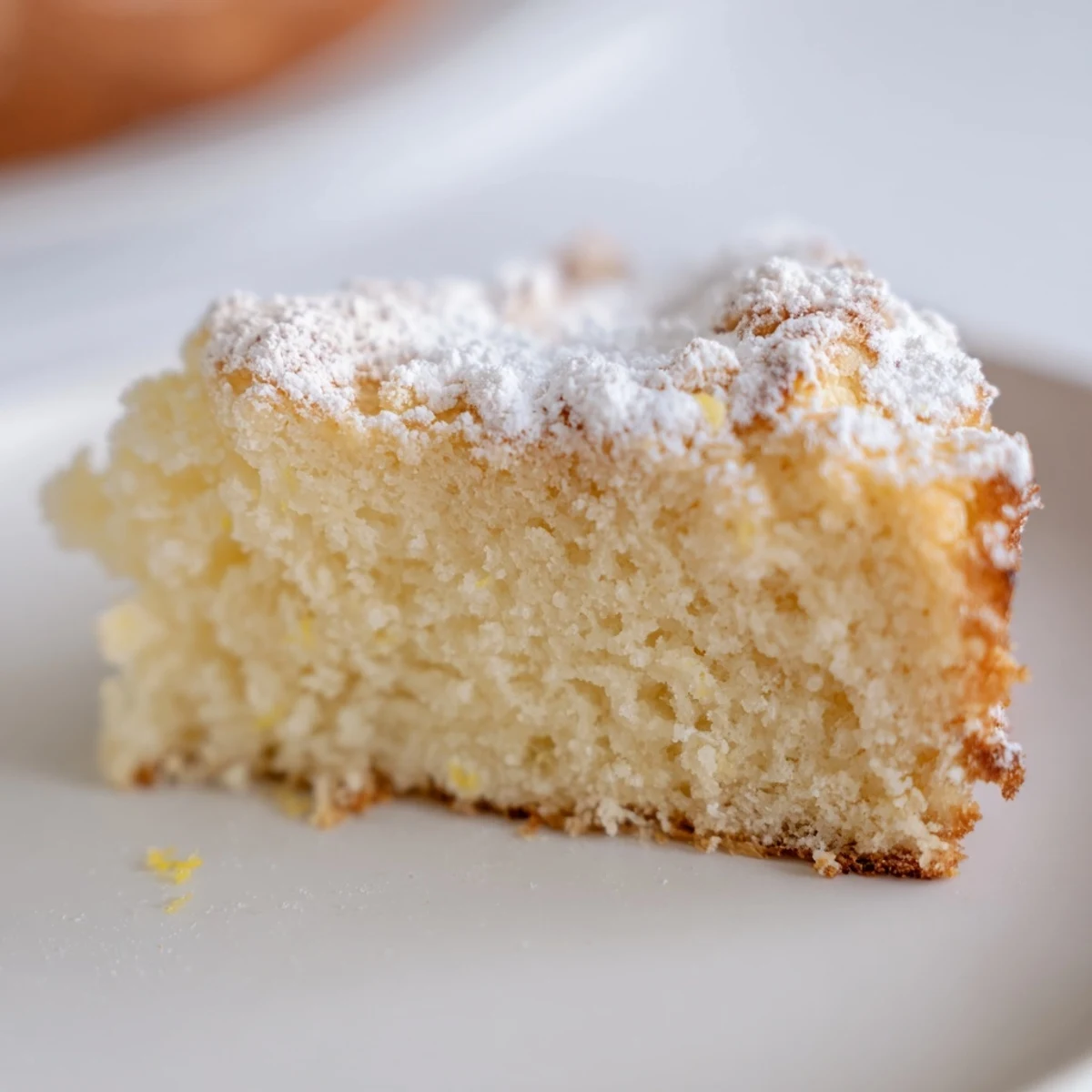 Fluffy Yogurt Cloud Cake stands tall on a wire rack with a delicate crumb, next to lemon zest and vanilla.
