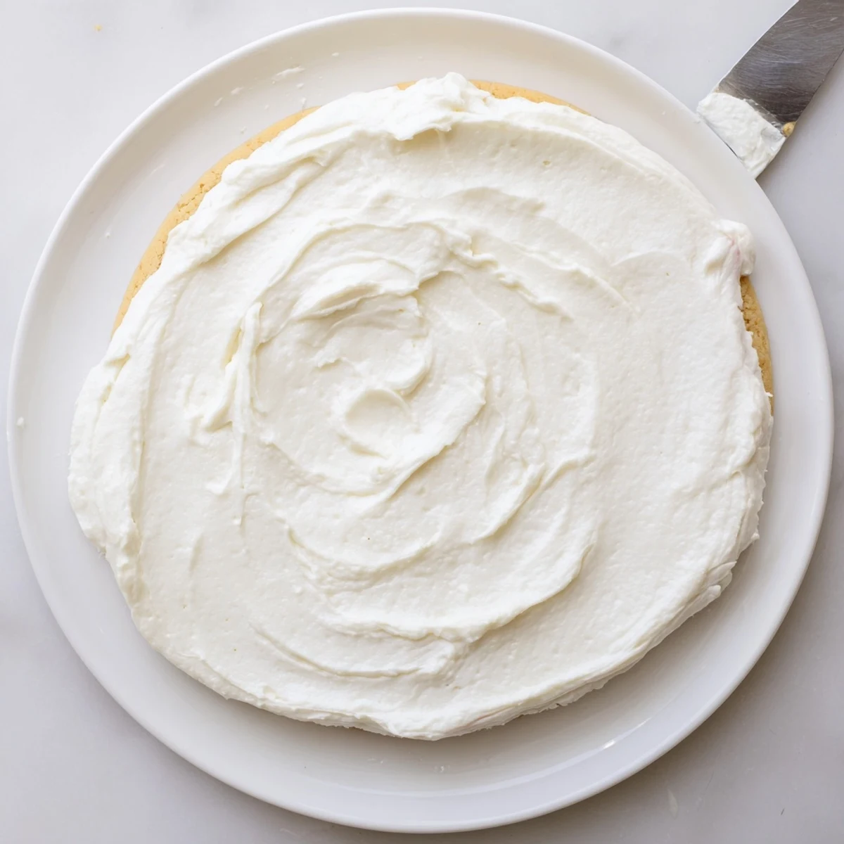 Easy Sugar Cookie Frosting pipes smoothly onto decorated cookies with fluffy texture and sweet vanilla aroma.