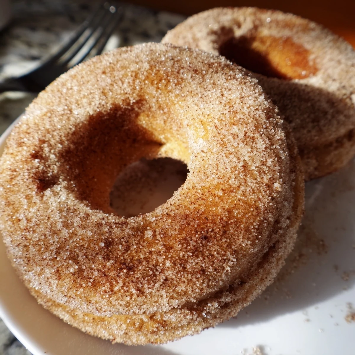 Freshly baked Delicious Baked Cinnamon Sugar Donuts You Cant Resist on a wire rack, warm and ready to serve.