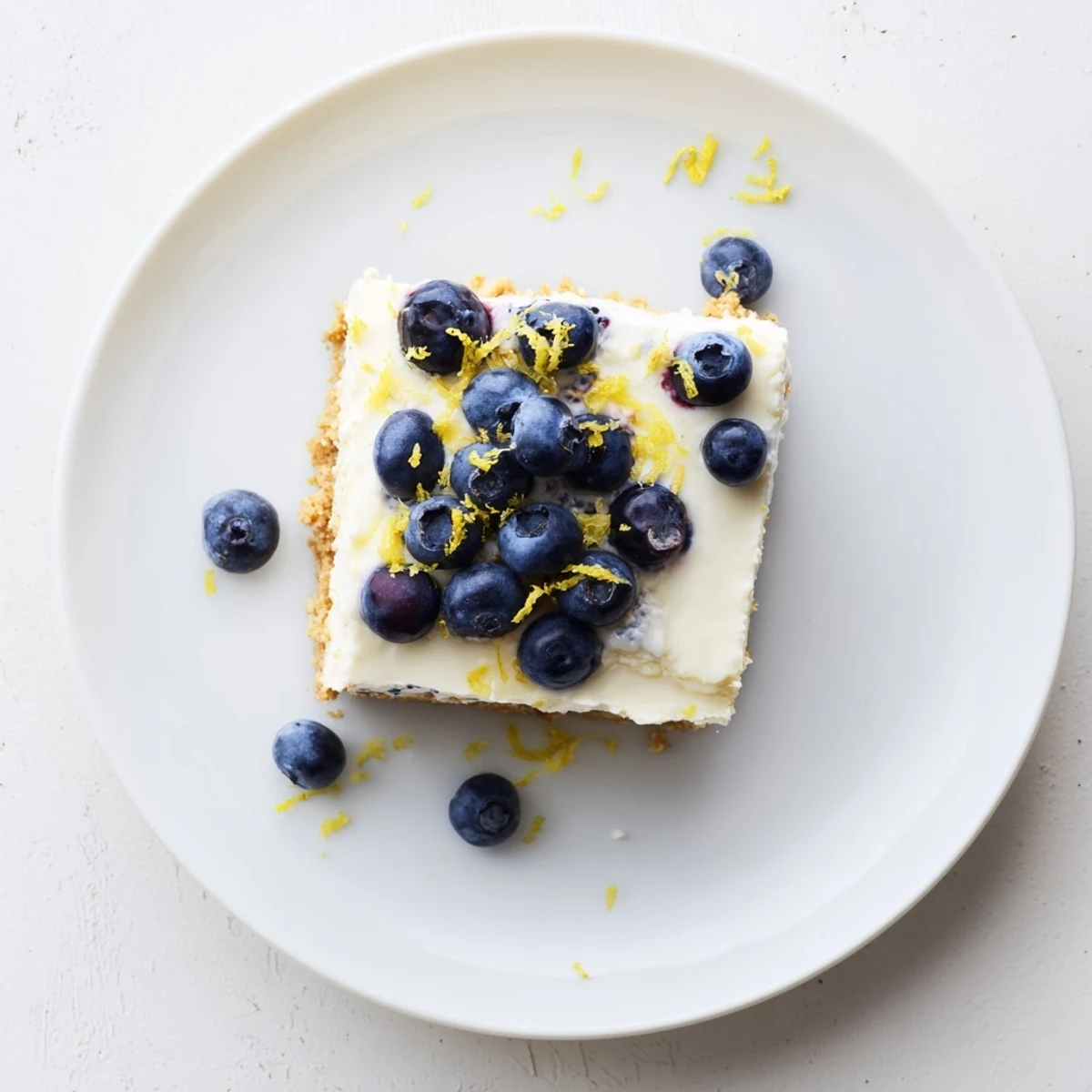 Summer ready no bake lemon blueberry cream cake served chilled with a dollop of whipped cream garnish.