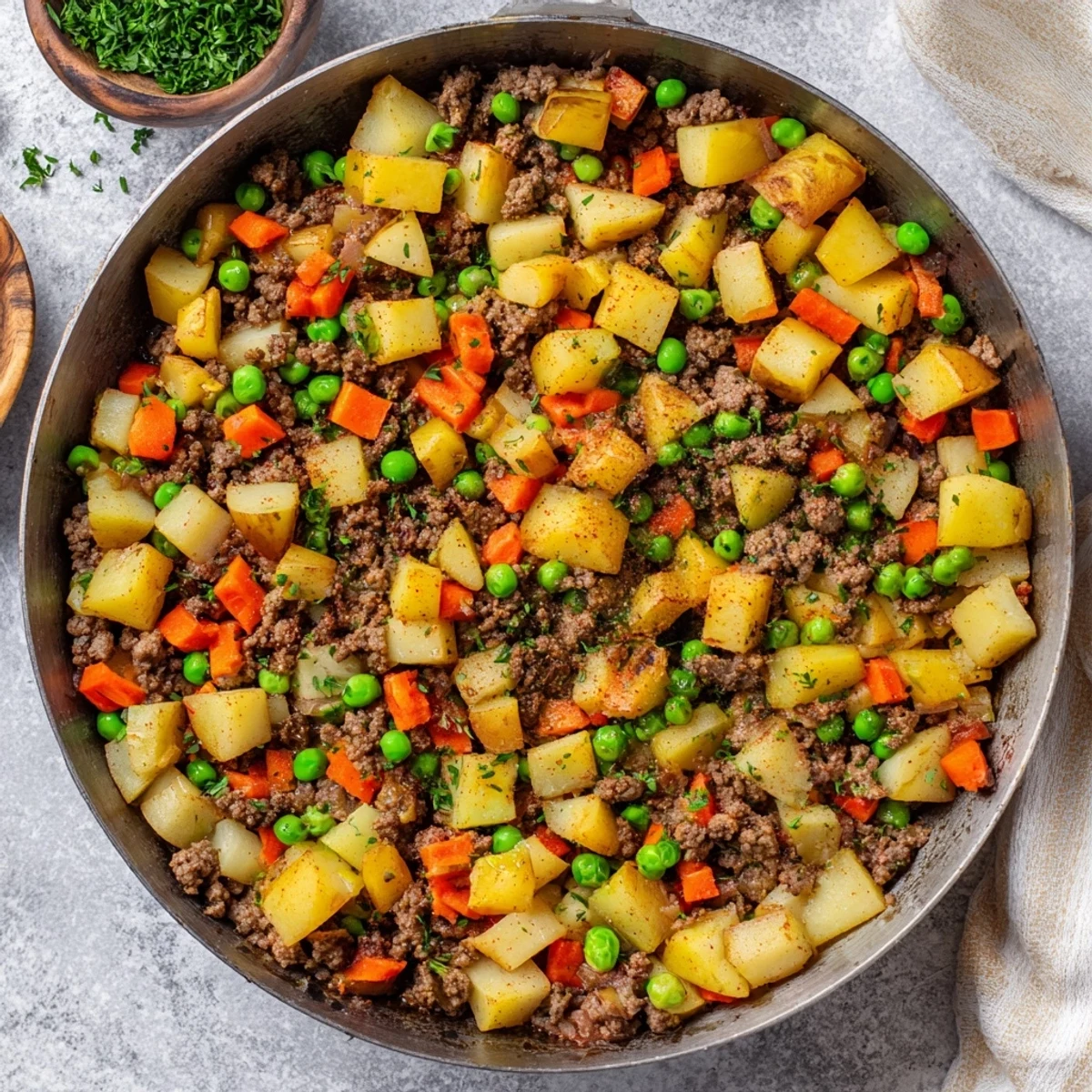 Hearty one pan ground beef and potatoes simmered in beef broth with carrots and green peas
