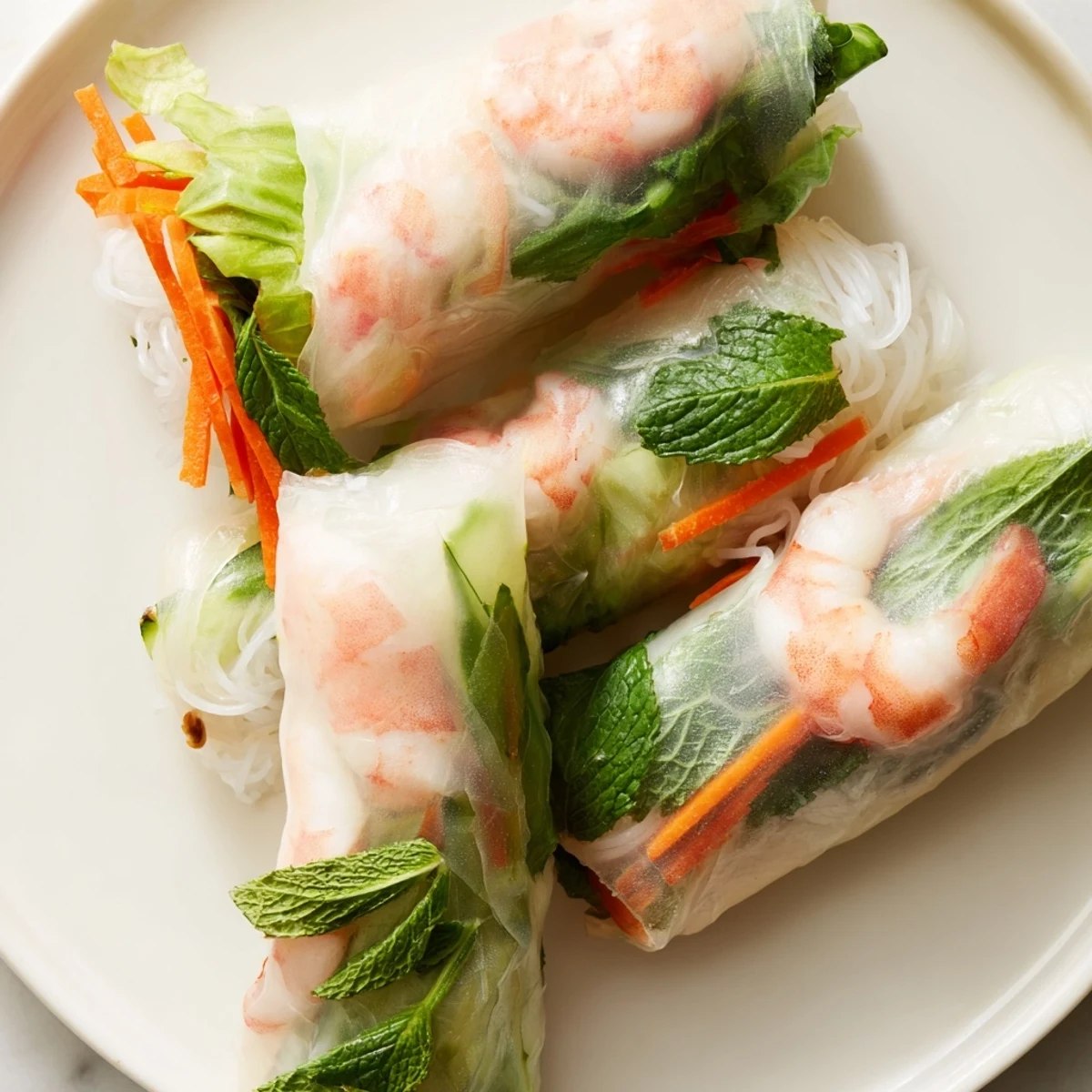 Fresh Vietnamese spring rolls with pink shrimp, crisp vegetables, and vermicelli noodles in translucent rice paper