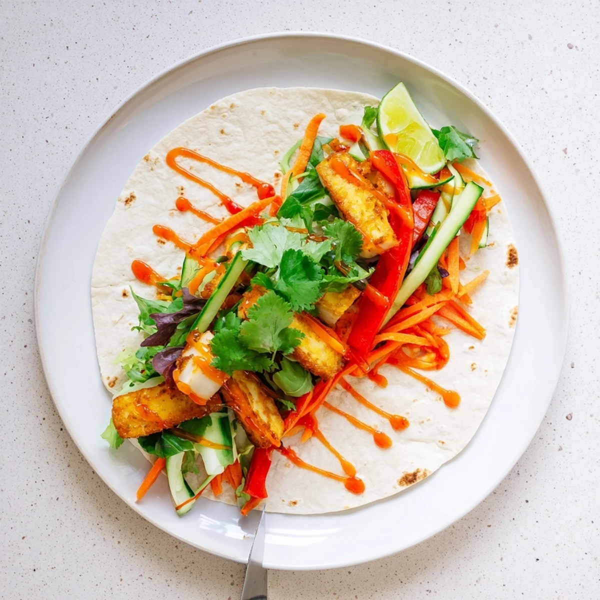 Fresh vegetarian sweet chili halloumi wraps filled with crisp bell peppers and cucumber