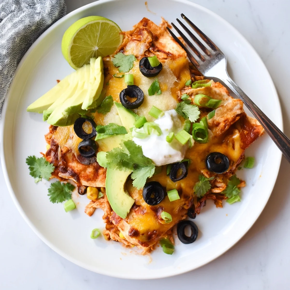 Cheesy Shredded Chicken Enchilada Bake with bubbling golden cheese and fresh cilantro garnish