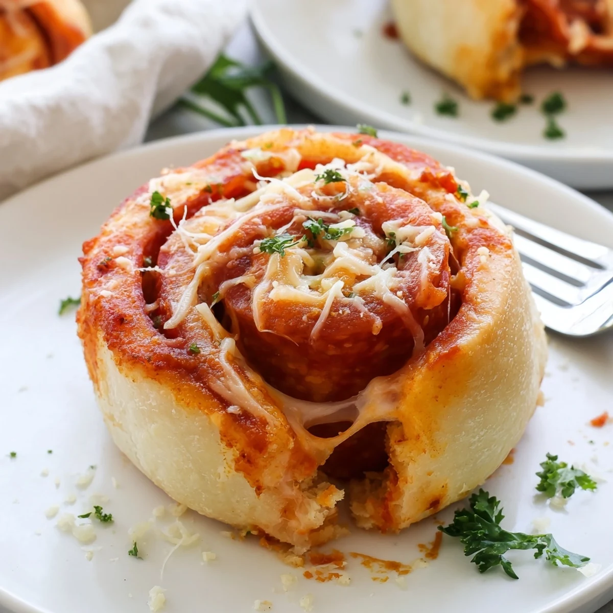 Fresh-baked Homemade Pizza Rolls cooling on parchment, pepperoni and melted cheese visible