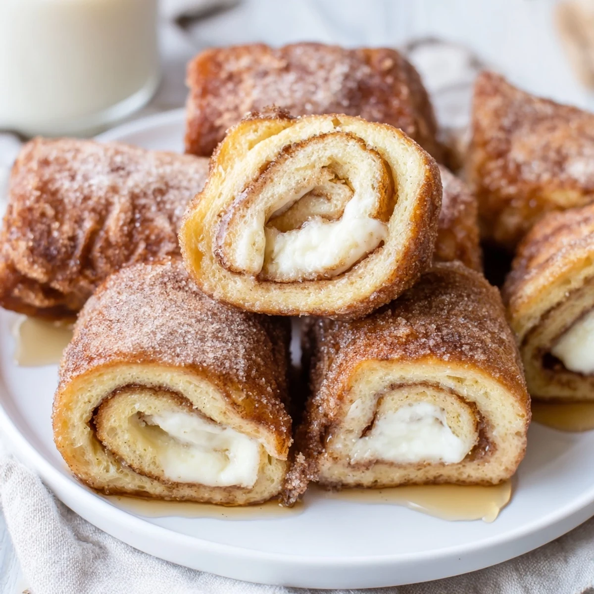 Warm Cinnamon Roll French Toast Roll Ups filled with sweet cream cheese