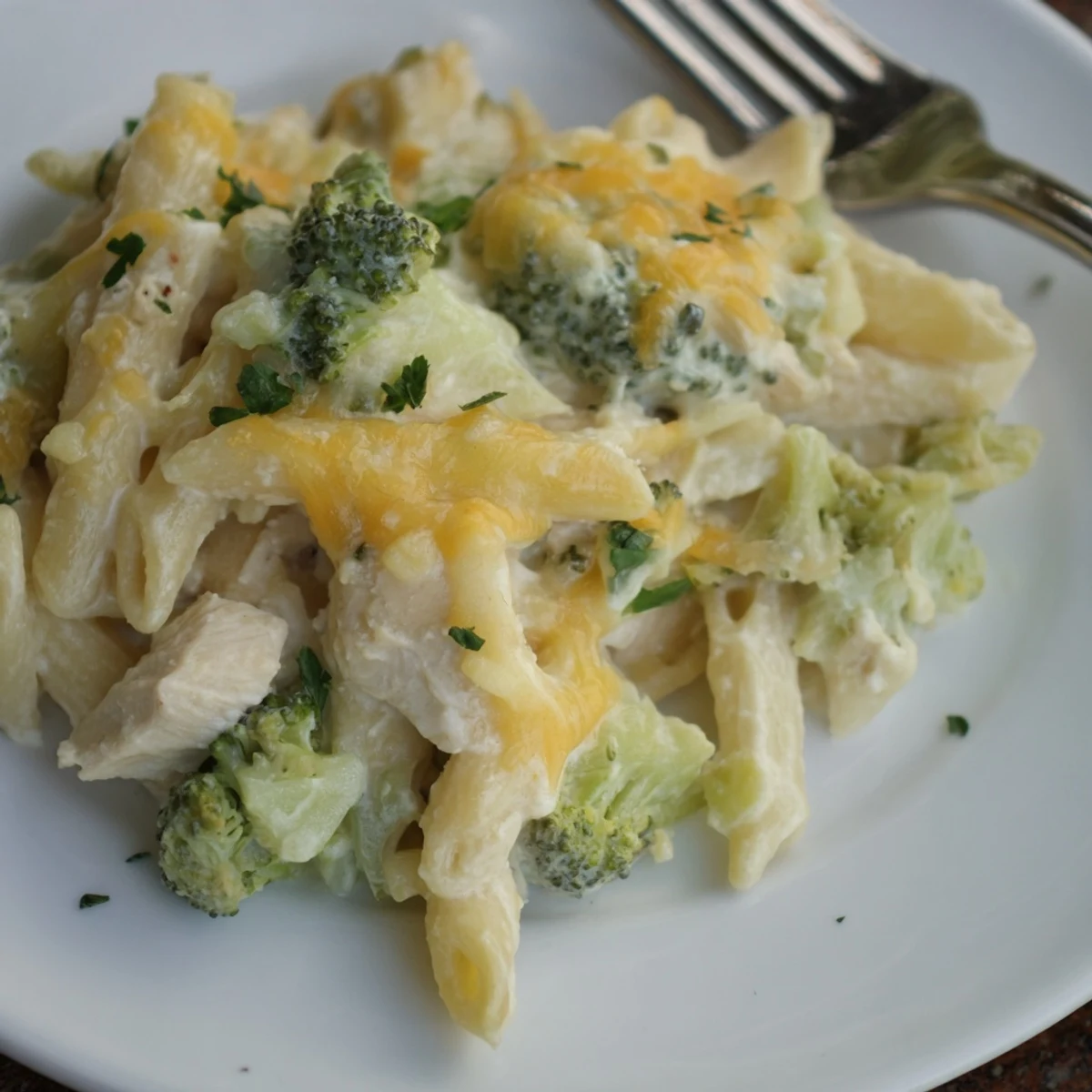 Oven-baked Chicken Broccoli Alfredo Bake served steaming with crusty garlic bread.  