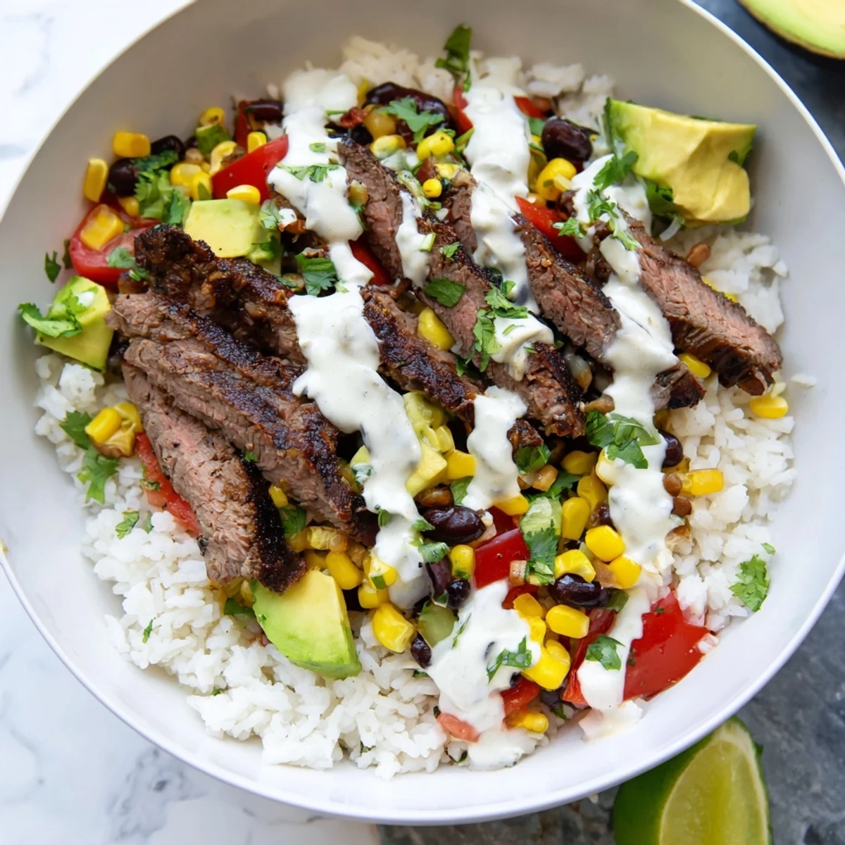Heaping bowl of spiced steak and fluffy rice smothered in melted cheddar cheese sauce