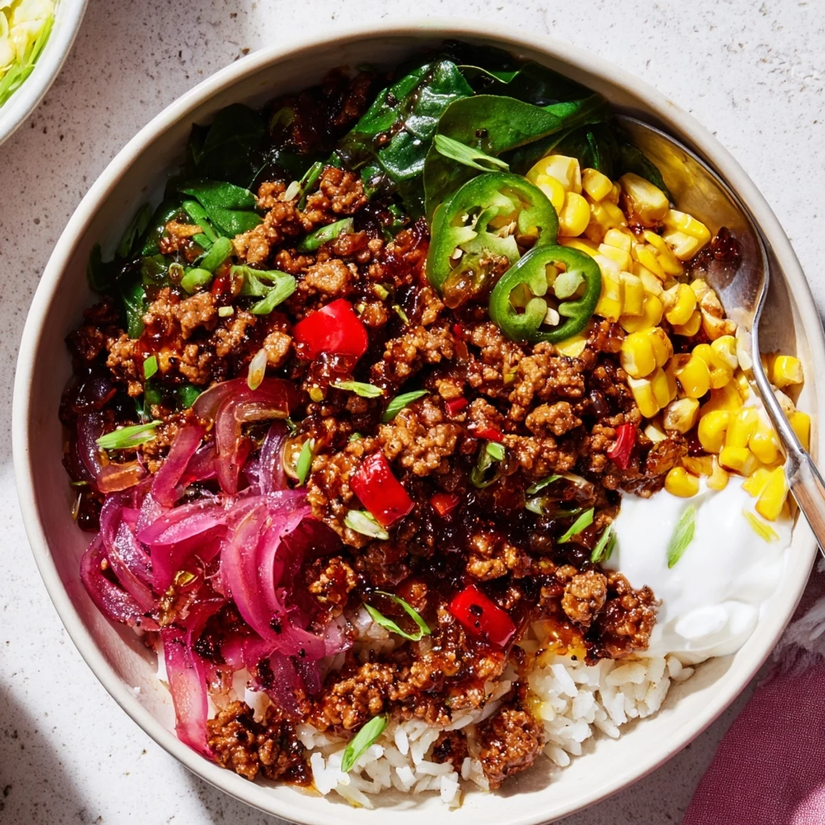 Viral Ground Beef Hot Honey Bowl layered over fluffy rice, cilantro and pickles