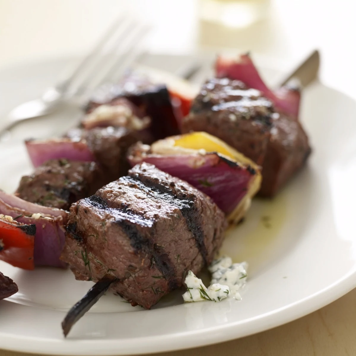 Baked or Grilled Greek Beef Kabobs With Whipped Feta Tzatziki Dip with charred peppers