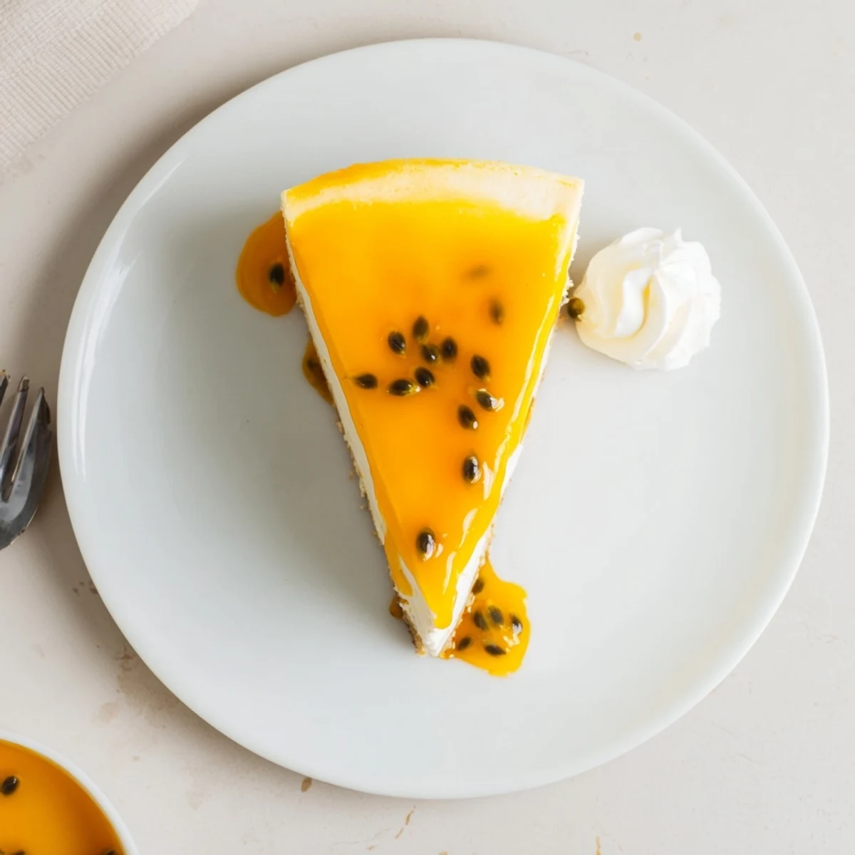 Mouthwatering Passion Fruit Cheesecake topped with glossy passion fruit glaze, sliced for serving