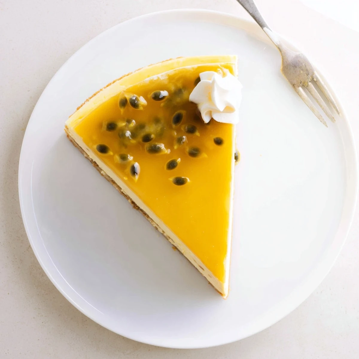 Sliced Mouthwatering Passion Fruit Cheesecake showing creamy texture and crunchy biscuit base