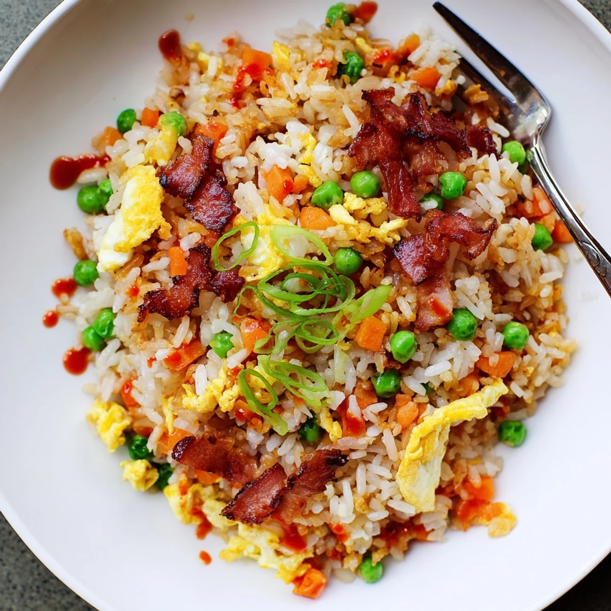 Quick Breakfast Fried Rice tossed with smoky bacon, jasmine aroma, sriracha drizzle