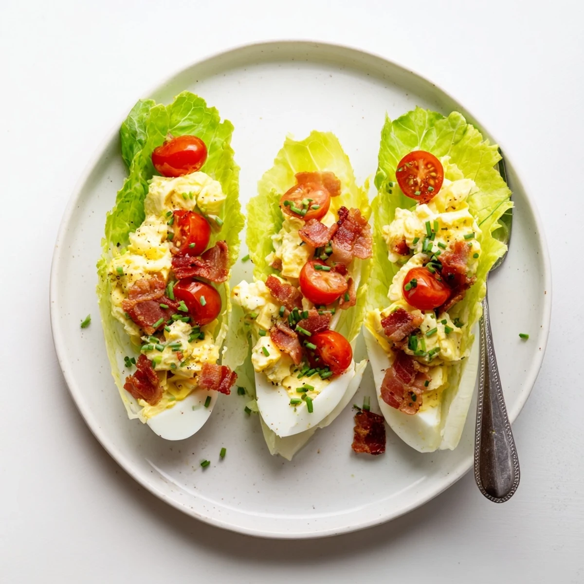 BLT Egg Salad Lettuce Wraps with creamy eggs, crispy bacon, and juicy tomatoes.