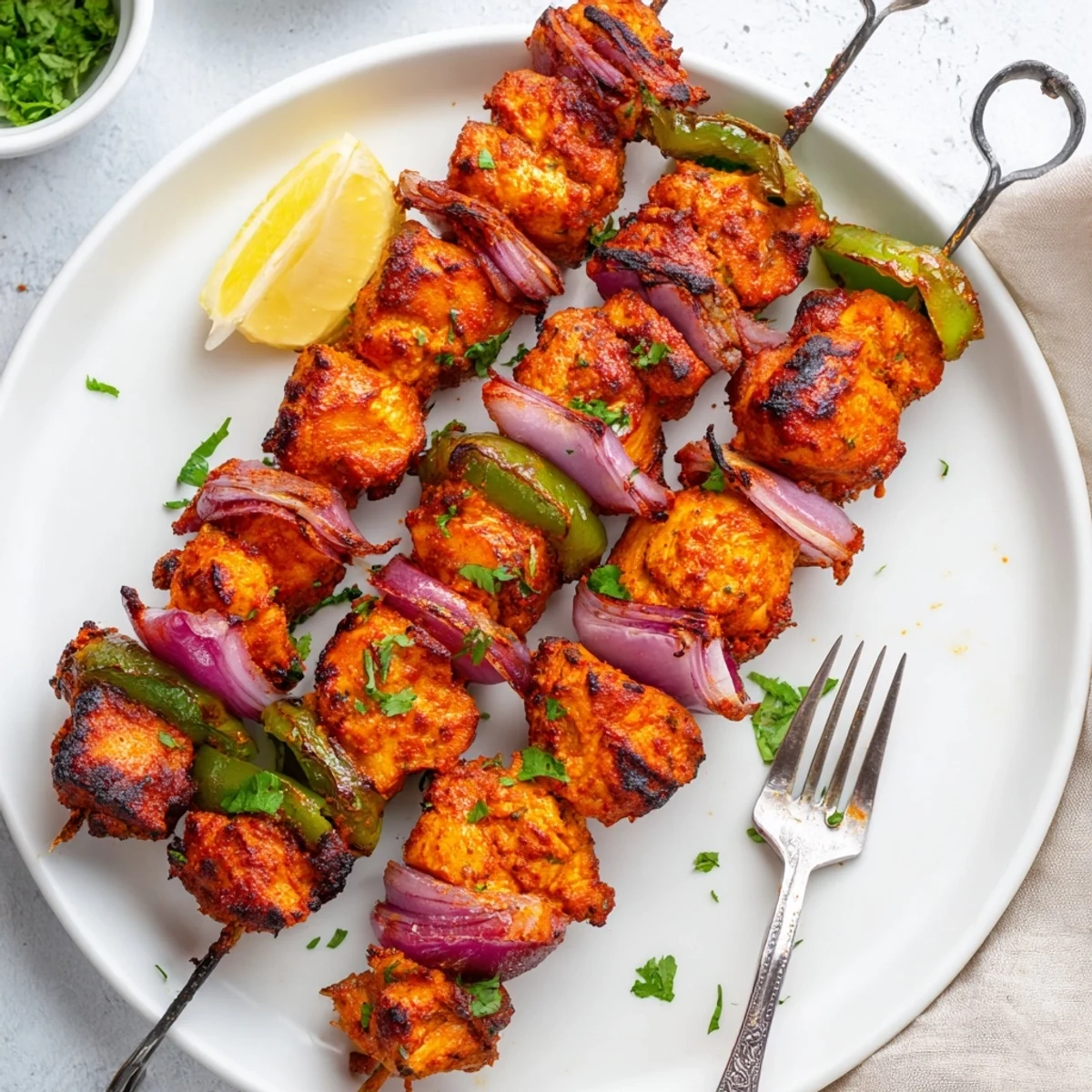 Tandoori Chicken Tikka Skewers threaded with peppers and onions, steaming hot and aromatic