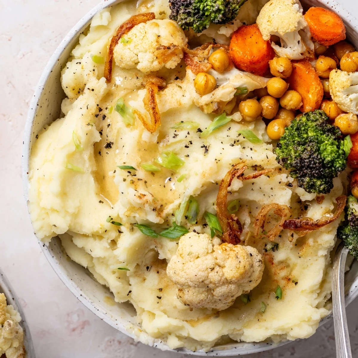 Creamy Vegan Mashed Potato Bowls topped with roasted vegetables and savory gravy.