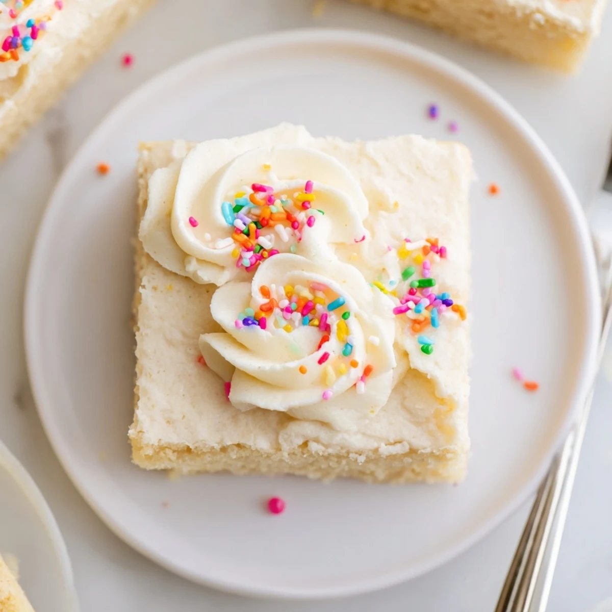 Frosted Sugar Cookie Bars Recipe: soft golden bars with creamy frosting and sprinkles