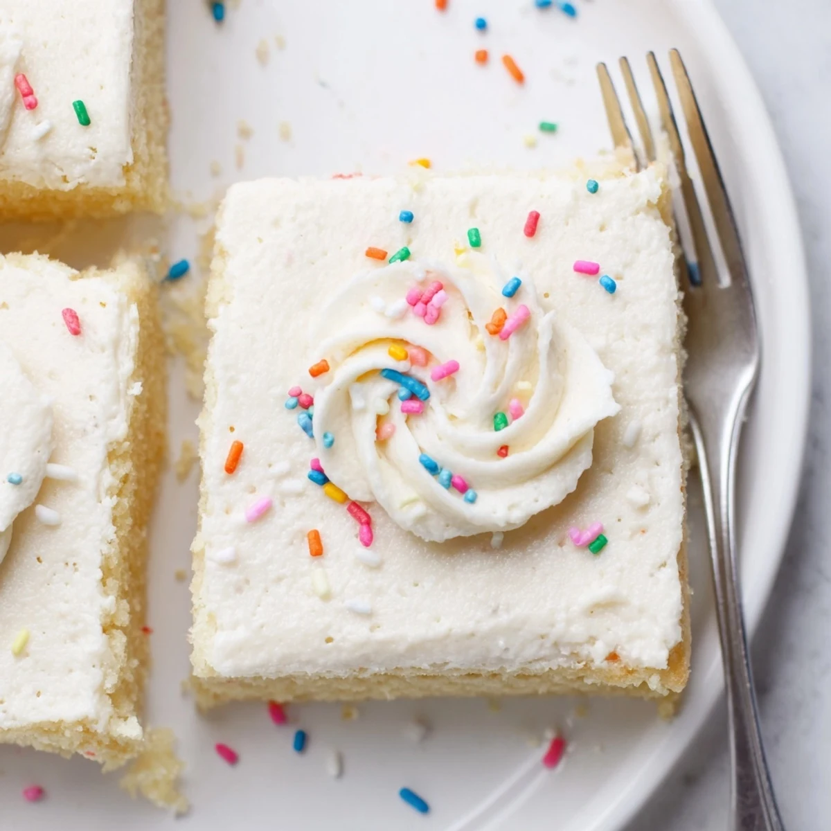 Close-up of Frosted Sugar Cookie Bars Recipe, buttery crumb and fluffy vanilla frosting