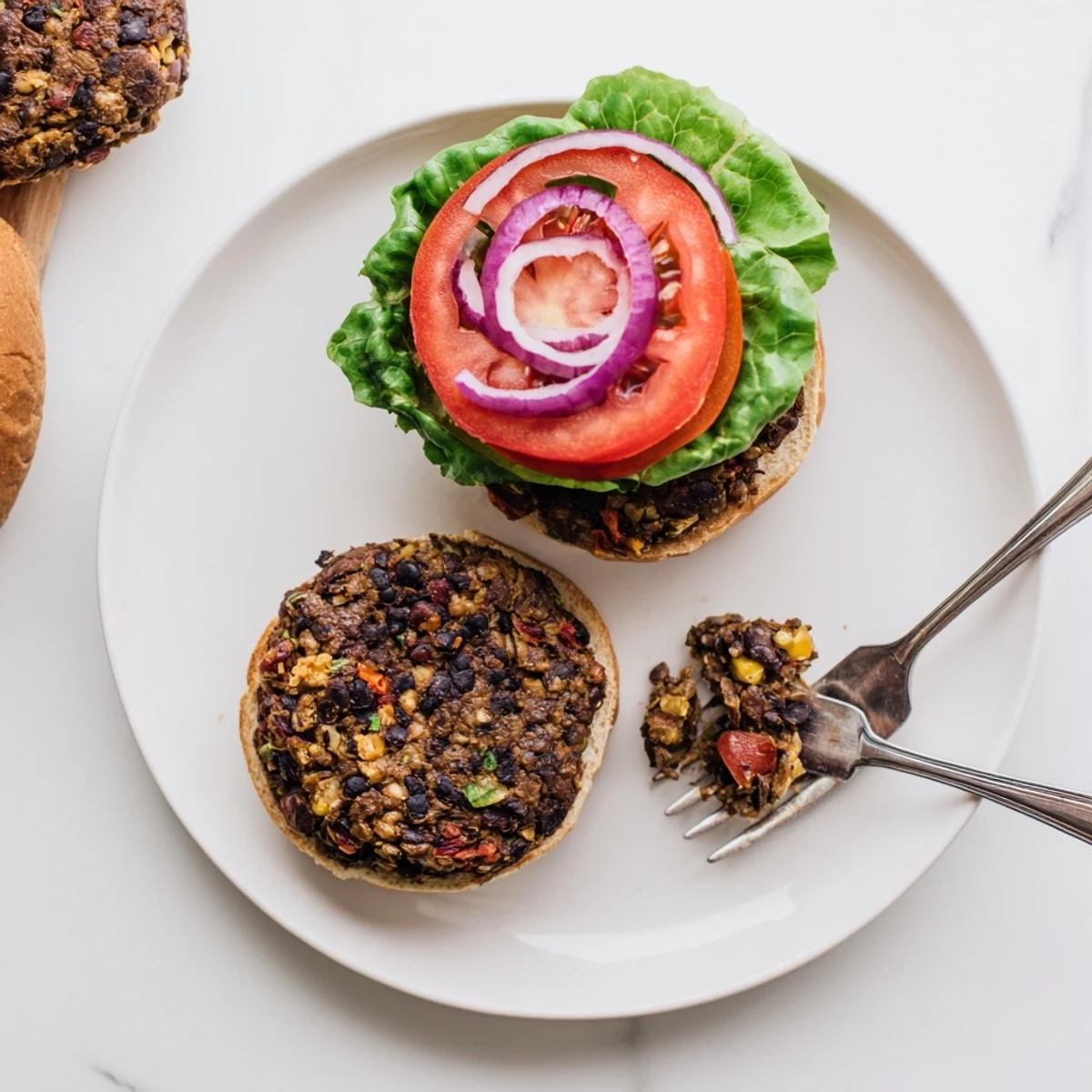 Golden brown veggie burgers recipe stacked on toasted buns with fresh lettuce and tomato slices