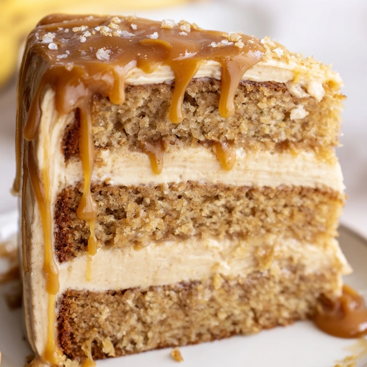 Decadent salted caramel brown butter banana cake topped with luscious caramel frosting and sea salt