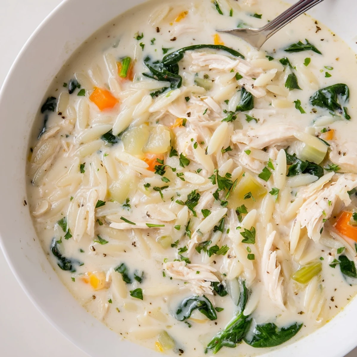 Creamy Chicken Florentine Soup With Orzo ladled over crusty bread, fragrant herb garnish.