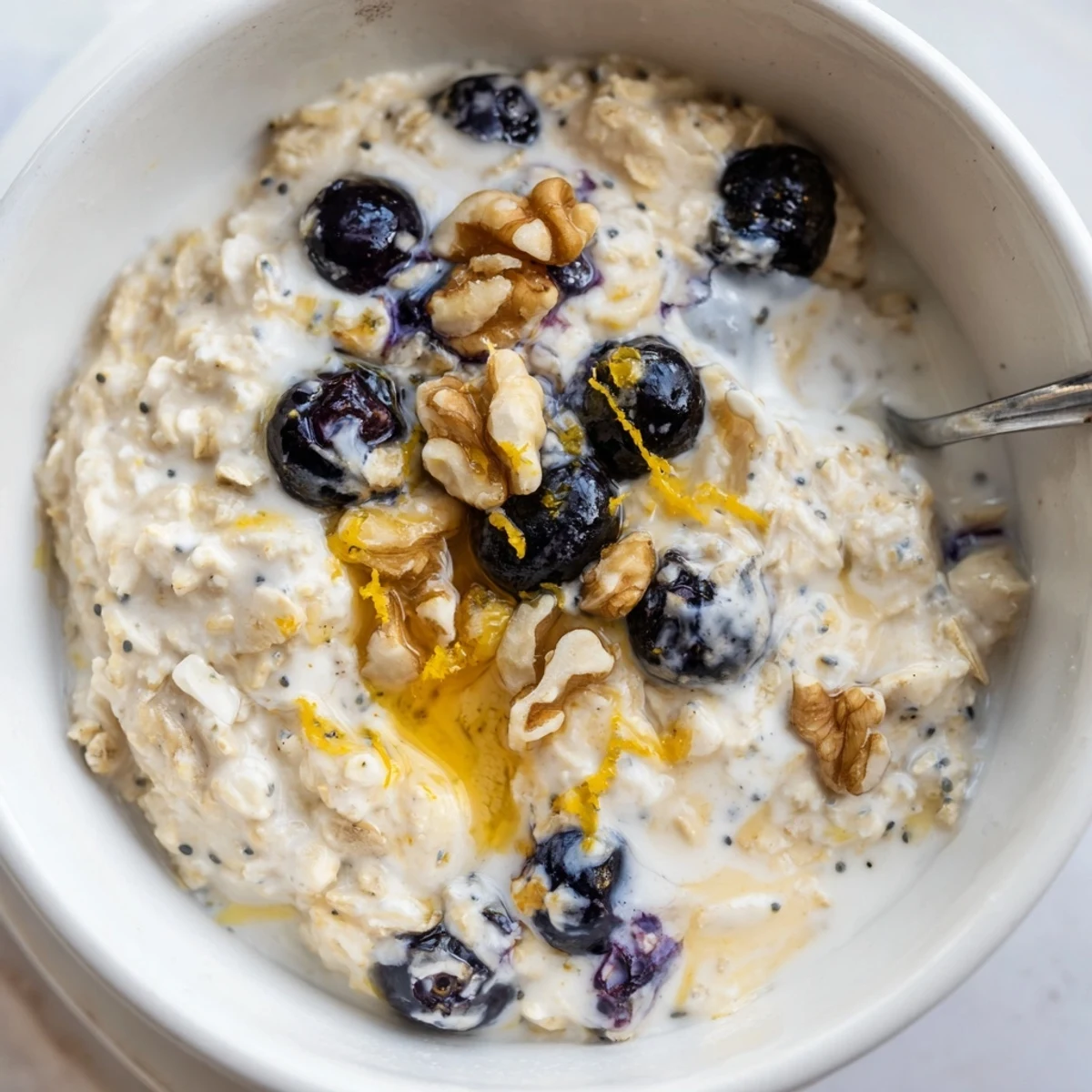 Creamy Blueberry Lemon Overnight Oats topped with fresh blueberries and lemon zest